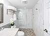 The generous walk-in shower and a natural pebble floor invites you to linger long after the beach.