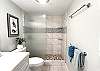Bright, clean bathroom with tropical details.