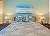 Experience the ultimate in relaxation in the serene bedroom with calming tones and island decor.