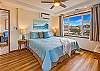 Serene primary suite with soft coastal light and relaxed tropical charm!