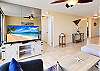 Entertainment center with smart TV and entryway leading to the quiet bedroom.