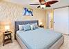 Settle into a king bed in this softly styled primary bedroom with bedside lamps.
