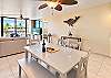 Indoor dining table with a view out to the ocean and private lanai.