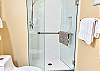 The primary bedroom features an ensuite bathroom with a granite vanity, modern lighting, and a step-in shower.
