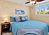 The second bedroom offers a King bed with bedside lighting.
