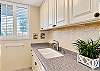A broad countertop provides room for meal preparation beside the stovetop and sink. 