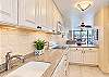 The kitchen opens to the dining area, keeping meal preparation close to everyone. 