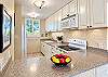 Prepare meals in this bright kitchen with an oven and stovetop and a full size refrigerator.