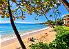 The outdoor beach area faces the turquoise ocean and neighboring island, as shown from this scenic angle along the coastline.