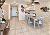 The dining table seats six, creating a convenient spot for chatting while meals are prepared.