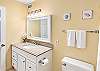 A thoughtfully arranged second bathroom provides convenient access and ample counter space for guests.