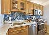 Tropical vibes in modern convenience blends seamlessly in this well-designed kitchen