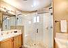 Master ensuite bathroom has two separate sink areas and large walk-in shower.