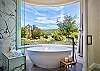 A soaking tub in the master suite offers amazing Avila Valley views. 