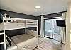 You'll find a bunk bed with a trundle underneath in the third bedroom. Both top and bottom bunks feature full-size mattresses,. The pull-out trundle has a a twin mattress. In total three sleeping beds. 