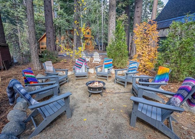 8 Adirondack chairs with Baja blankets perfectly arranged around a propane Fire Pit (weather permitting).