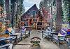 Outdoors patio and 8 Adirondack chairs with Baja blankets perfectly arranged around a propane Fire Pit (weather permitting).
