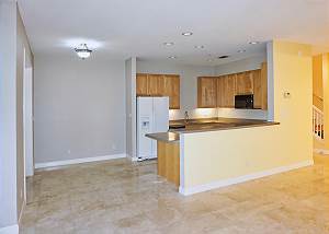 View of the open kitchen and a place for a small dinette or cabinets from the living room