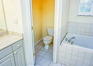 There is a privacy pocket door for the restroom which is located between the tub and vanity.