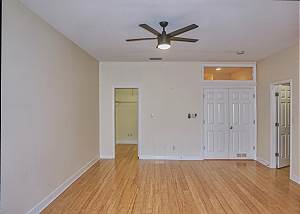 From the balcony end of the suite looking towards the double entry doorway to the right. The second walk in closet is to the left.