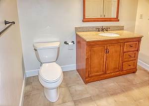 The Guest Bath upstairs with Mirrored Sink and Storage.