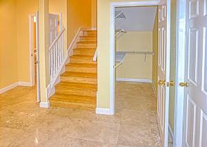 Your view from the foyer as you enter, to the right is the garage door entry. The downstairs has a huge walk in storage closet, stairs to the upper level and a half bath to the left of the stairway.
