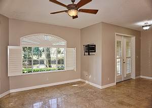 The open living room, dining room and kitchen downstairs, the french doors to the right lead to the screened in back patio.