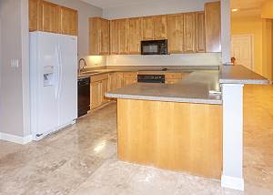 The kitchen wraps around and easily accessible from the dining and living area.