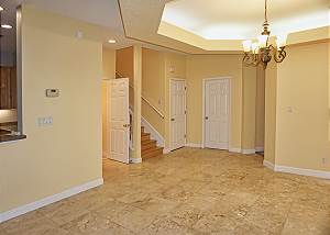 This view shows the entry and dining area, theres a half bath located next to the stairway.