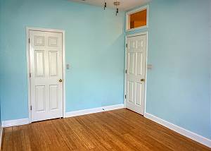 From the window corner in the second guest bedroom, the closet to the left and the entry door is to the right.