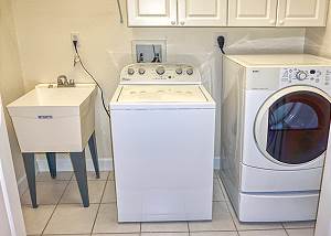 The laundry room is located upstairs across from the shared Guest Bedrooms Bath.