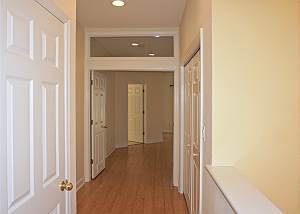 The top of the stairs to your right, this is the view of the Master Entry, to the right are the doors to the laundry, to the left the guest bedrooms bath.