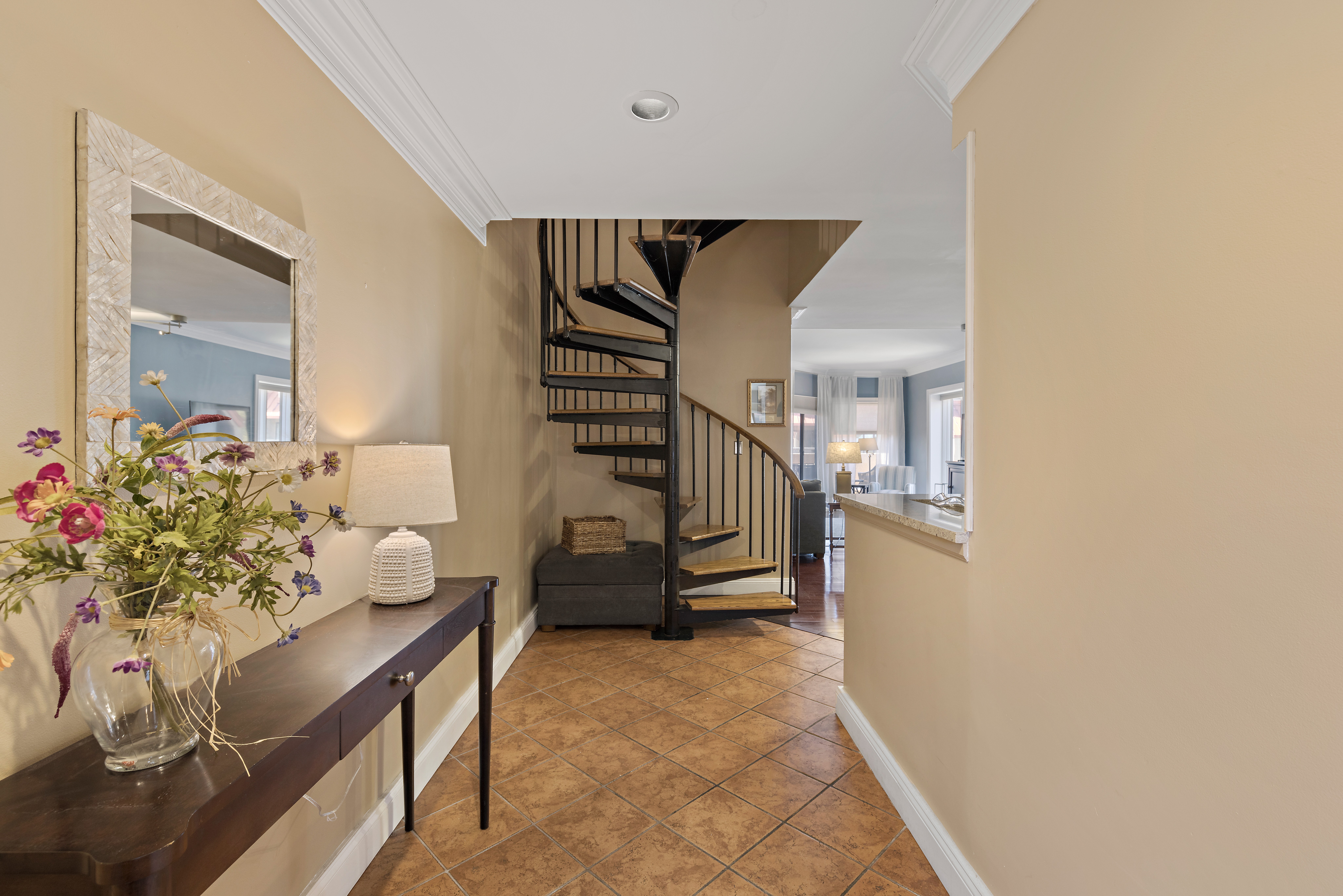 Warm & Airy Hallway Leading To the Spiral Staircase