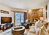 View of Gas fireplace, large screen TV and outdoor deck with Views of Vail Mountain.