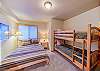 Guest bedroom with queen bed and bunk beds