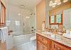 The third bathroom with a shower & tub combination.