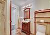 The bathroom features a walk-in shower. An ample supply of plush towels is provided.