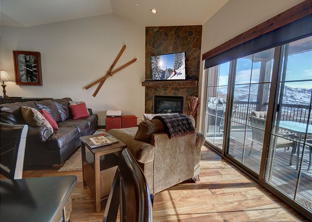 Main Living Room with TV, Gas Fireplace, Comfortable Seating and Balcony with Seating and Views!