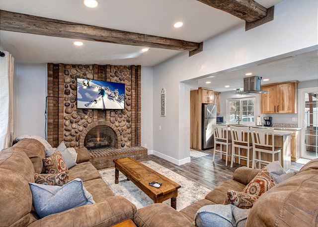 Main Level Living Area with Comfortable Seating, TV and Large Stone Fireplace