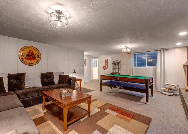 Lower Level Family Room with Large Stone Fireplace, Pool Table, 55" Smart TV and Comfortable Seating