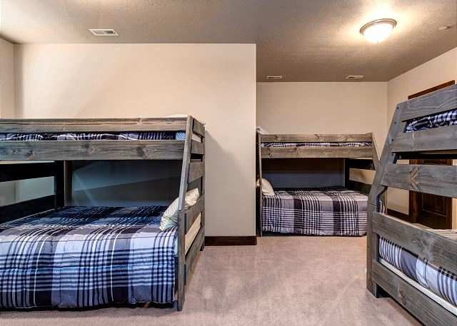 On the lower level, a large bedroom with three Twin-over-Full bunkbeds, a 35” TV, and full bathroom with tub/shower combination makes a perfect place for kids to hang out and play.