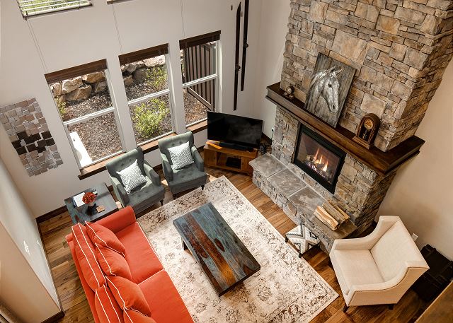 The beautifully-decorated, open main level features a gorgeous living room with plenty of seating, a 60” HD TV with Apple TV hooked up, a cozy gas fireplace.