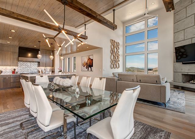 Dining Room: The dining area is stunning with its glass top table with seating for up to 12 and exquisite views throughout. Step out onto a massive deck to enjoy the mountain fresh air and views.  Adorned with a new gas BBQ grill, dining table for 10 and 
