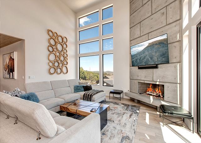 Living Room: Gorgeous and comfortable with a large sectional sofa with adjustable headrests, and floor-to-ceiling stonework with a cozy gas fireplace and a 75" Smart TV. The AV system is complete with a Sonos Surround system that also provides sound and m