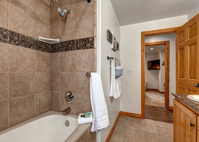Full bathroom with dual sink vanity and 6' long, deep soaking tub and shower with rain head. The home as a tankless water heater for endless hot water!