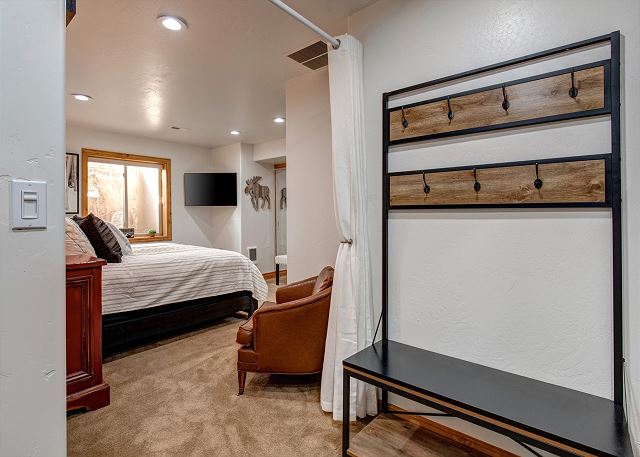 LARGE bedroom with King bed and Queen-over-Queen built-in bunk beds. Each area of the bedroom has its own 4k Ultra HD Samsung Smart TV and there is a curtain to separate the sleeping areas.