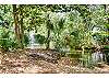 Xanadu's grounds with a lagoon and water fountain.