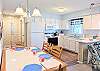 Open-concept kitchen and dining space at Bethany Meadows with white cabinetry and modern appliances.