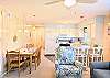 Cozy dining space at Bethany Meadows with a wooden table adjacent to a bright, white-cabinet kitchen.