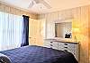 Comfortable room at D4 Briar Court with a large mirror and white storage console.